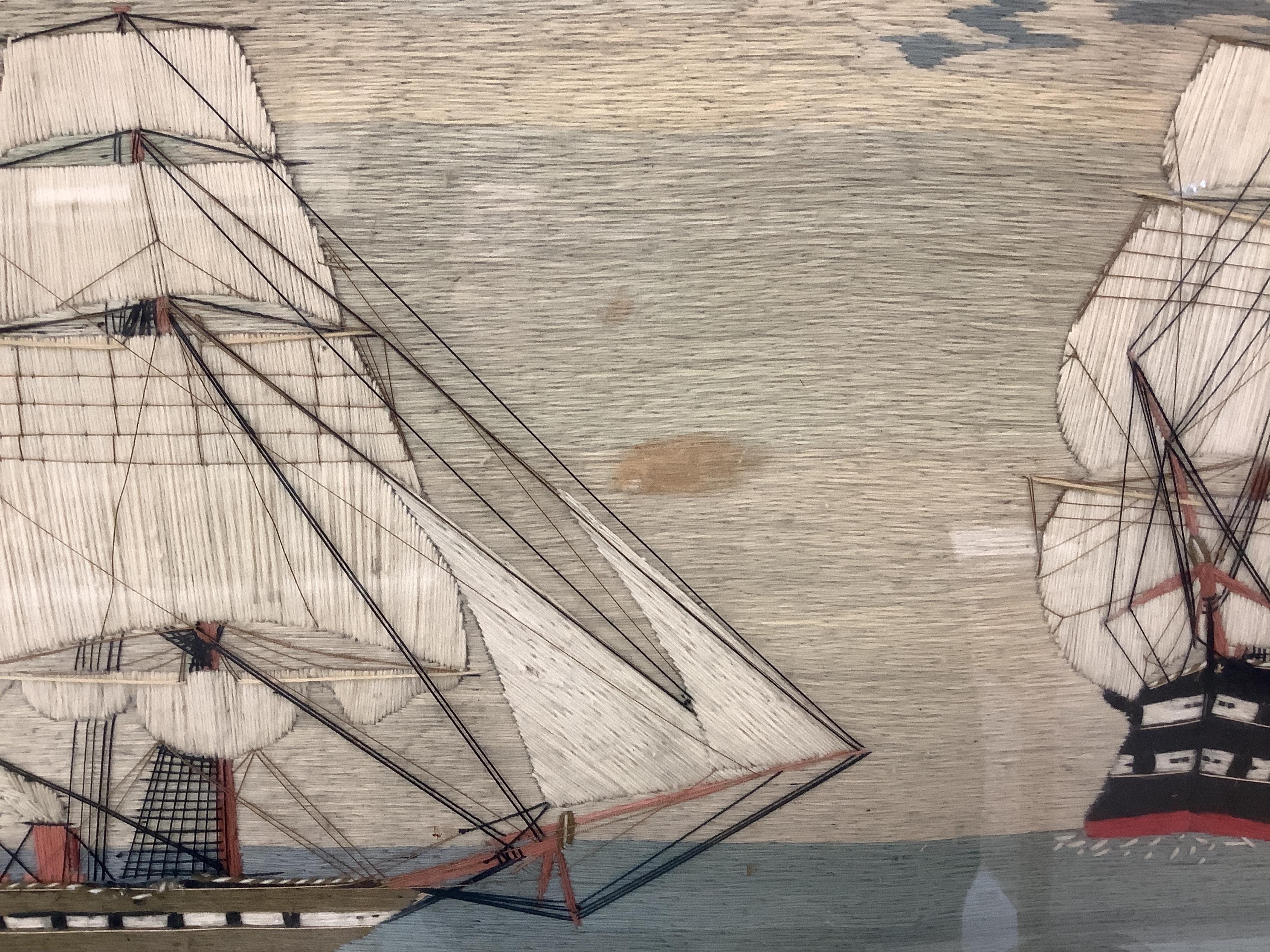 A large 19th century folk art ‘sailors woolie’ embroidery, of a naval steam ship and a frigate, both flying the Royal Navy ensign. 74cm x 39cm.
